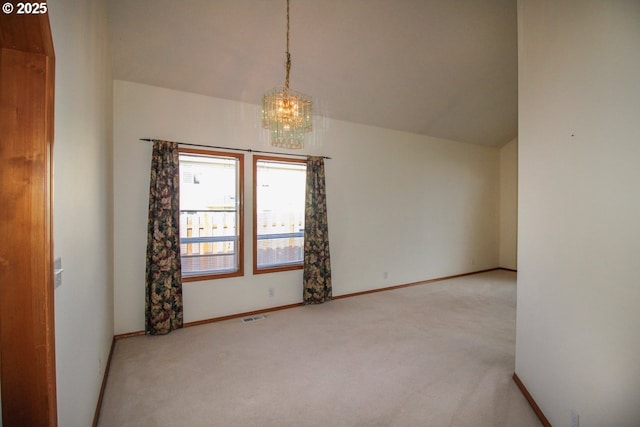 carpeted empty room featuring visible vents, baseboards, an inviting chandelier, and vaulted ceiling