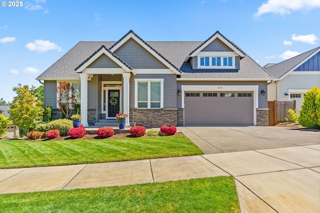 craftsman-style house featuring stone siding, concrete driveway, an attached garage, and a shingled roof