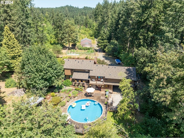 drone / aerial view with a wooded view
