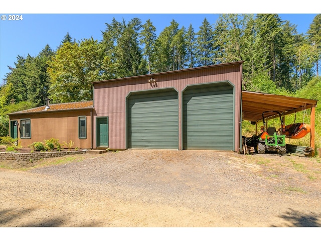 garage with a detached garage and driveway