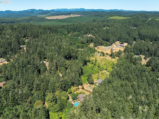 birds eye view of property with a view of trees and a mountain view