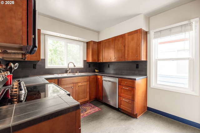 kitchen with stainless steel dishwasher, a sink, brown cabinets, decorative backsplash, and tile countertops
