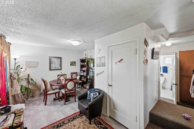dining area featuring a textured ceiling