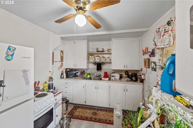 kitchen featuring white appliances, a sink, light countertops, white cabinets, and a ceiling fan