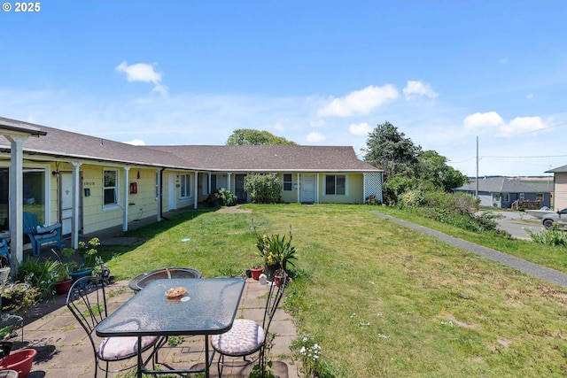 view of front of house featuring a front lawn and a patio area