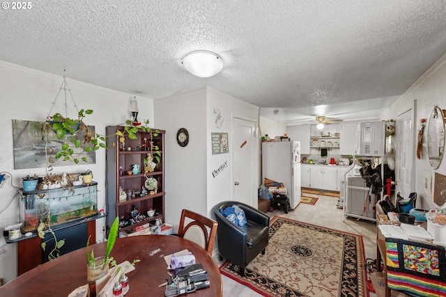 dining area featuring a textured ceiling, a ceiling fan, and light floors