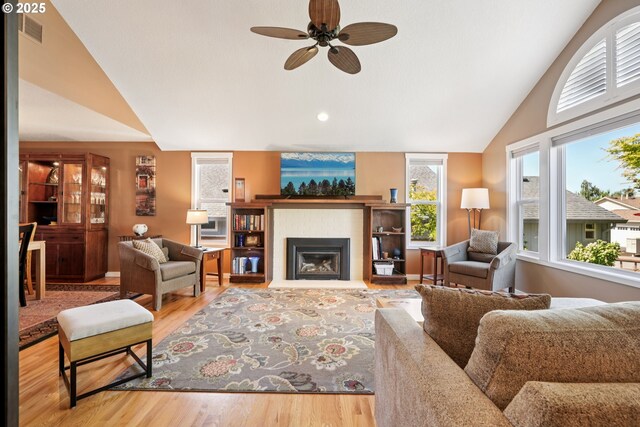 3119 SE 154th Ave, Vancouver, WA 98683 - living area featuring wood finished floors, ceiling fan, a glass covered fireplace, and high vaulted ceiling
