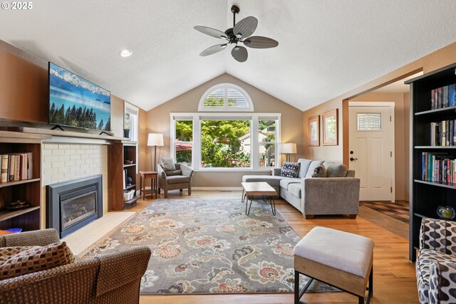 3119 SE 154th Ave, Vancouver, WA 98683 - living room with a ceiling fan, wood finished floors, lofted ceiling, a textured ceiling, and a fireplace