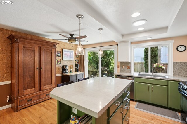 3119 SE 154th Ave, Vancouver, WA 98683 - kitchen with green cabinets, light wood-style flooring, ceiling fan, stainless steel dishwasher, and light countertops