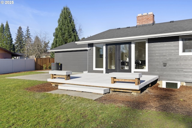 rear view of house featuring a patio area, a lawn, and a deck