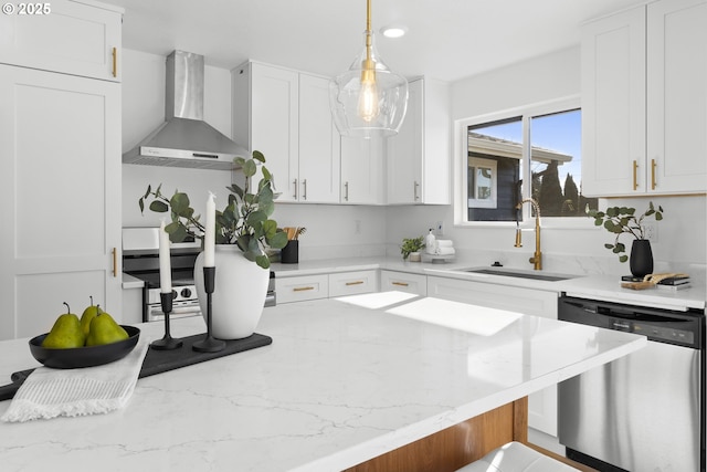 kitchen featuring white cabinetry, sink, stainless steel dishwasher, and wall chimney exhaust hood