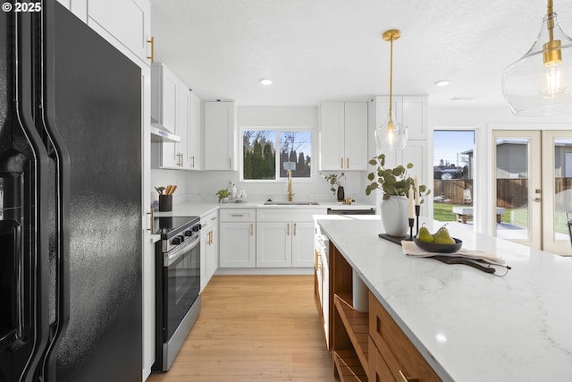 kitchen with electric stove, sink, white cabinets, and black refrigerator with ice dispenser