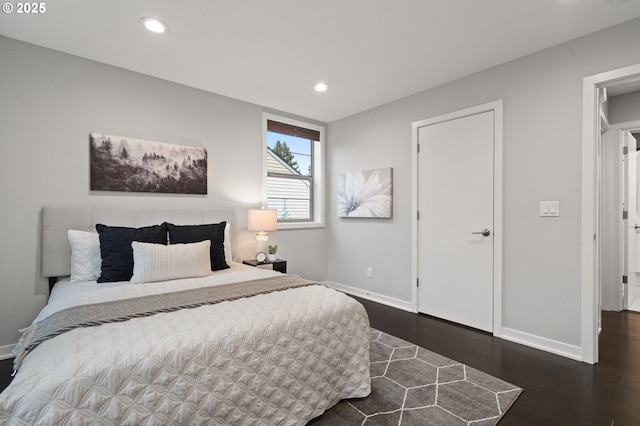 bedroom with dark hardwood / wood-style floors