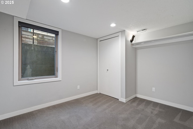 unfurnished bedroom featuring carpet flooring and a textured ceiling