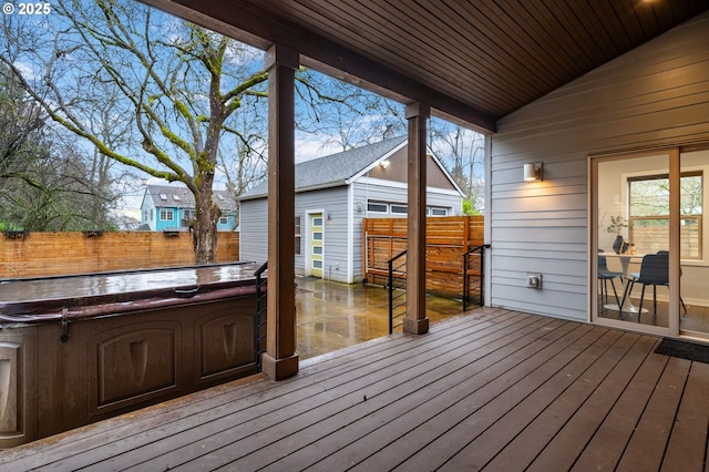 wooden deck featuring a hot tub