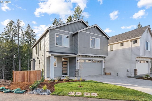 view of front of property with an attached garage, driveway, and a front yard