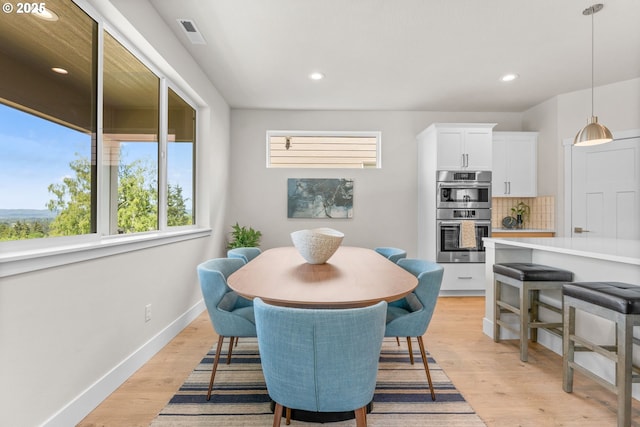 dining room with light wood-type flooring