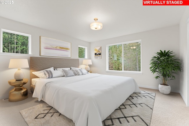 carpeted bedroom featuring baseboards