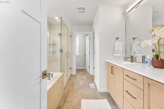 bathroom with vanity and shower with separate bathtub