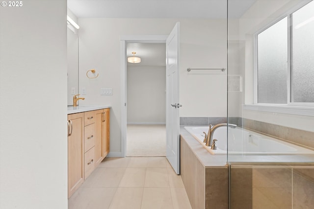 bathroom featuring a garden tub, tile patterned flooring, baseboards, and vanity