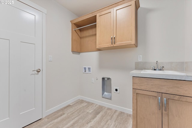 laundry area featuring washer hookup, cabinet space, light wood-style floors, hookup for an electric dryer, and a sink