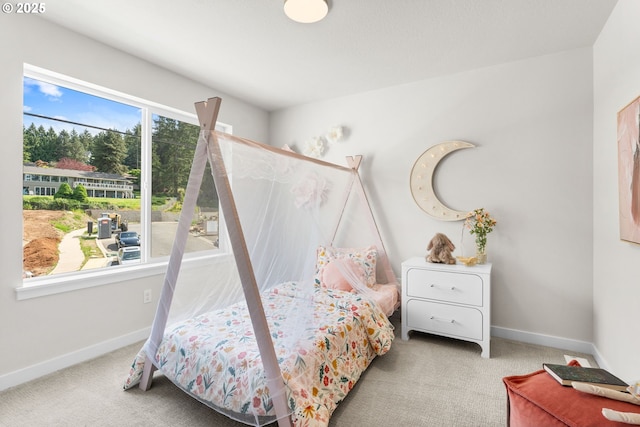 bedroom with multiple windows and light colored carpet