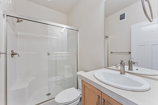 bathroom with toilet, a stall shower, visible vents, and vanity