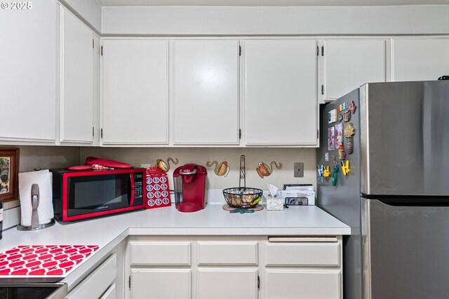 151 Treehill Loop, Eugene, OR 97405 - kitchen with freestanding refrigerator, light countertops, and white cabinets