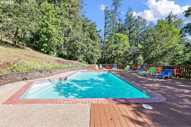 151 Treehill Loop, Eugene, OR 97405 - view of swimming pool featuring a wooden deck and view of wooded area