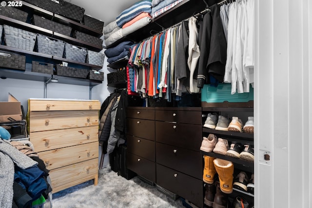 walk in closet featuring light carpet