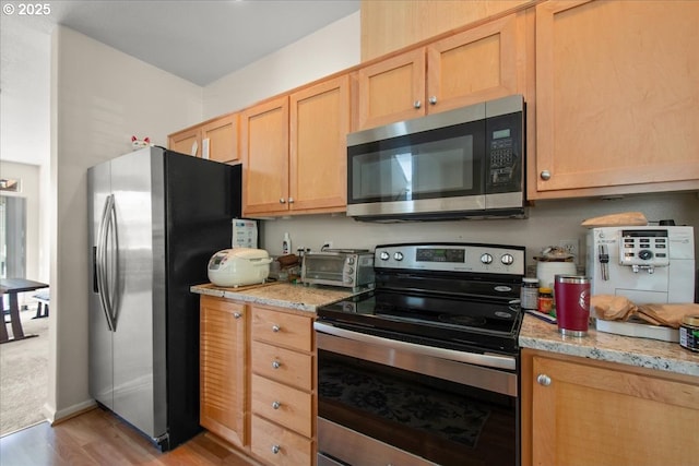 10238 NE Snoqualmie St, Hillsboro, OR 97006 - kitchen with stainless steel appliances, light wood finished floors, and light stone counters