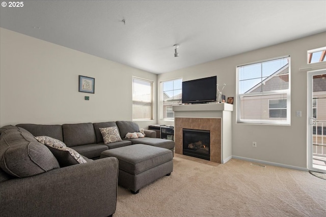 10238 NE Snoqualmie St, Hillsboro, OR 97006 - living area featuring a fireplace, light colored carpet, plenty of natural light, and baseboards