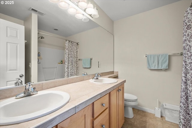 10238 NE Snoqualmie St, Hillsboro, OR 97006 - bathroom featuring double vanity, toilet, curtained shower, tile patterned flooring, and baseboards