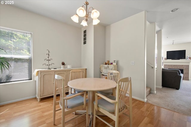 10238 NE Snoqualmie St, Hillsboro, OR 97006 - dining space with baseboards, a chandelier, light wood finished floors, and stairway