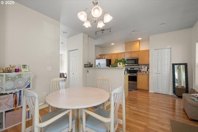 10238 NE Snoqualmie St, Hillsboro, OR 97006 - dining room with light wood-style flooring, a chandelier, and recessed lighting