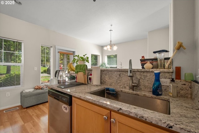 10238 NE Snoqualmie St, Hillsboro, OR 97006 - kitchen featuring dishwasher, a sink, light wood-type flooring, light stone countertops, and a chandelier