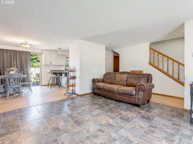 611 NW 4th Pl, Battle Ground, WA 98604 - living room featuring a textured ceiling, stone finish flooring, and stairway