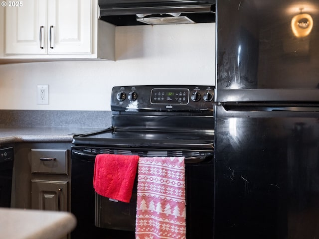 611 NW 4th Pl, Battle Ground, WA 98604 - kitchen with black appliances, extractor fan, and white cabinetry