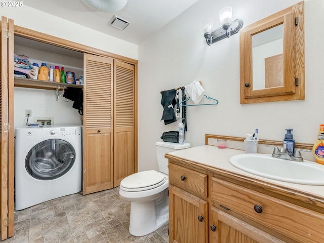611 NW 4th Pl, Battle Ground, WA 98604 - bathroom featuring washer / clothes dryer, a closet, vanity, and stone finish floors