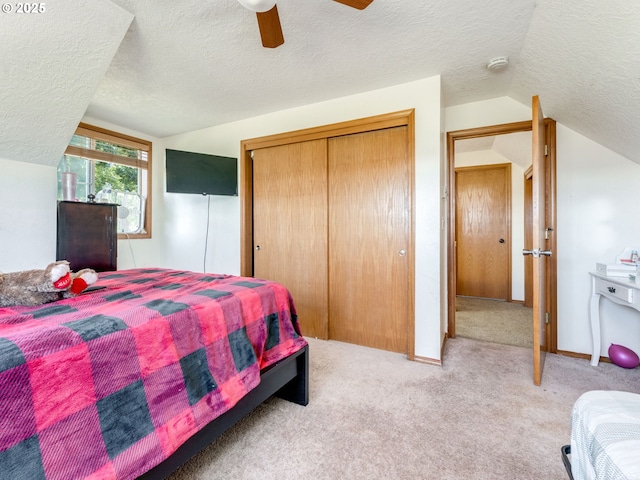 611 NW 4th Pl, Battle Ground, WA 98604 - bedroom with a textured ceiling, vaulted ceiling, light carpet, a closet, and ceiling fan