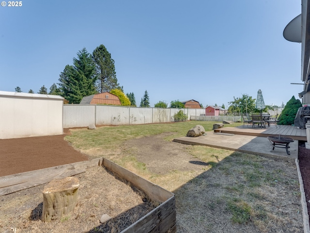 611 NW 4th Pl, Battle Ground, WA 98604 - fenced backyard with a patio, a deck, and a vegetable garden