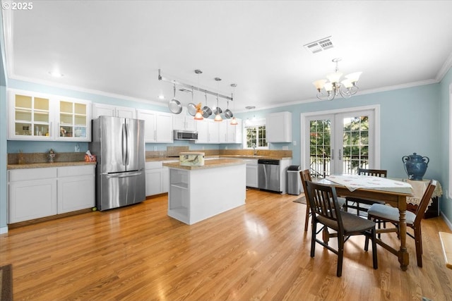 165 Lynn Ct, Winchester, OR 97495 - living room with a chandelier, light wood-style flooring, plenty of natural light, ornamental molding, and a ceiling fan