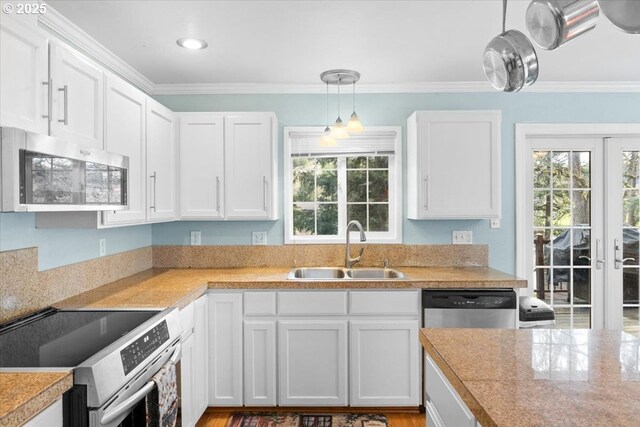 165 Lynn Ct, Winchester, OR 97495 - kitchen featuring appliances with stainless steel finishes, crown molding, a chandelier, french doors, and white cabinets