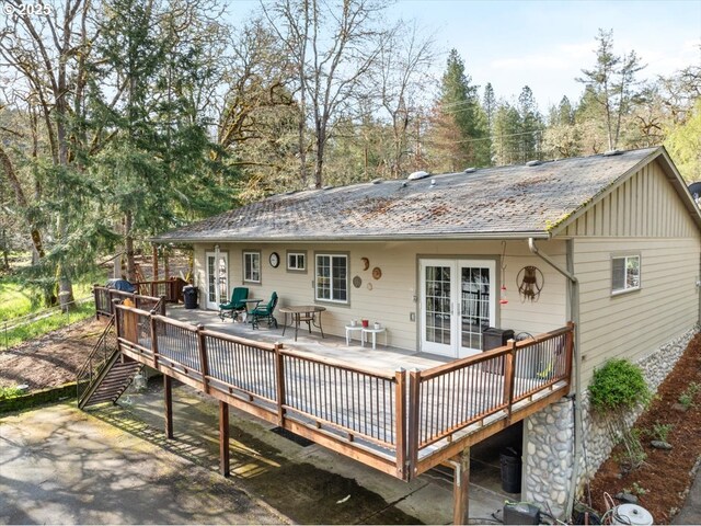 165 Lynn Ct, Winchester, OR 97495 - back of property featuring stairway, a wooden deck, a yard, and stone siding
