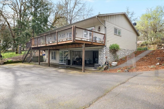 165 Lynn Ct, Winchester, OR 97495 - view of front facade featuring stone siding, an outdoor fire pit, and a shingled roof