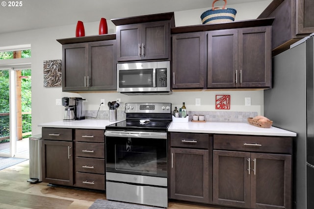 1345 Skyline Park Loop, Eugene, OR 97405 - kitchen with appliances with stainless steel finishes, light countertops, dark brown cabinetry, and light wood-style floors