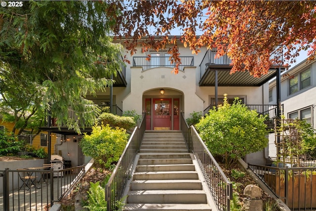 doorway to property featuring stucco siding