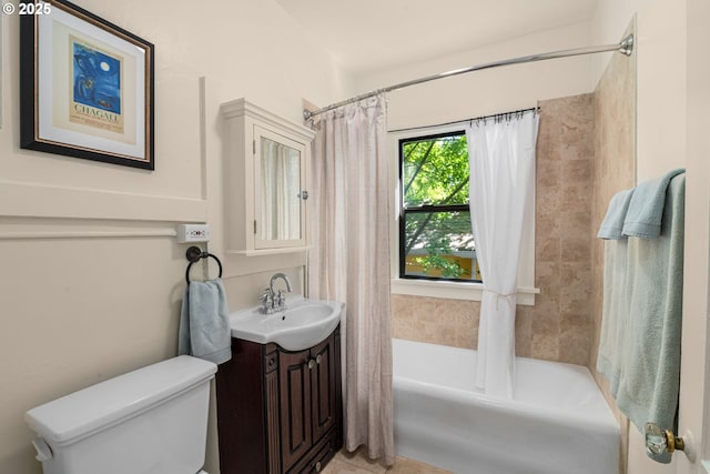 bathroom with vanity, shower / tub combo, and toilet