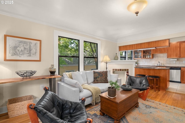 living room featuring light wood-style floors and crown molding