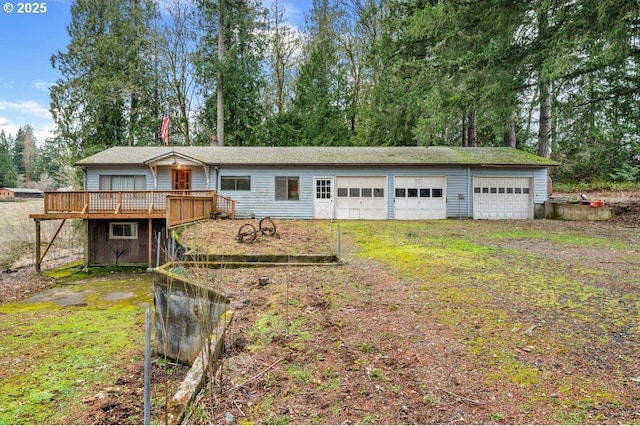 single story home with an outdoor structure and a wooden deck